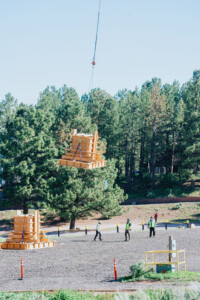 Wooden form for concrete being lifted into the sky.