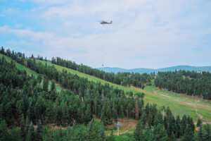 Blackhawk helicopter carrying concrete for on of the tower bases.