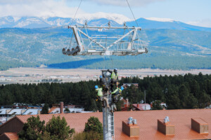 Lowering a cross arm on to one of Angel Express' towers.